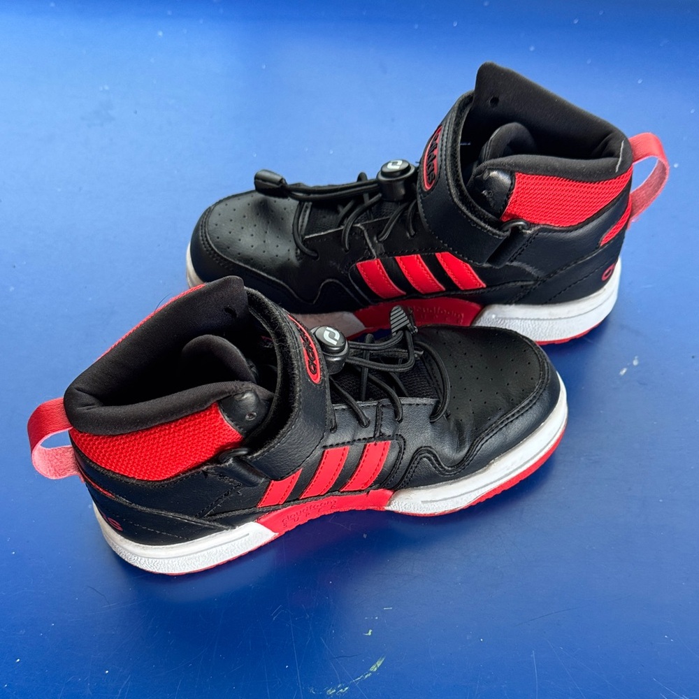 Black and red kids high top Adidas sneakers